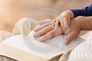 Grandpa Reading to Baby Boy From the Bible photo