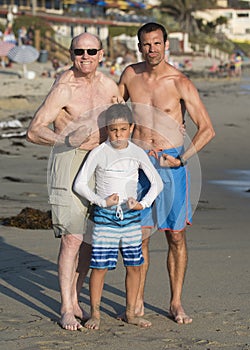 Grandpa, son, and grandson flexing thier muscles on Venice Beach