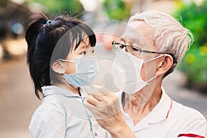 Grandpa spoke with her grandchild to understand how to wear a face mask to help prevent the spread of coronavirus and PM2.5.