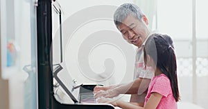 Grandpa teach girl play piano