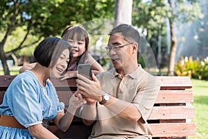 Grandparent enjoy with granddaughter in park surrounded with greenery and serenity. having joyful and cheerful time