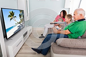 Grandparent And Grandchildren Watching Television Together