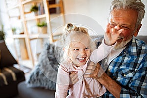 Grandparent playing and having fun with their granddaughter
