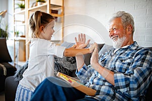 Grandparent playing and having fun with their granddaughter