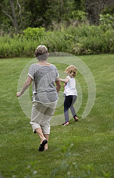 Grandparent playing with young girl