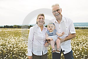 Grandparent spending time with little child during the sunset.