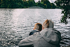 Grandparent taking care of grandchild at lake