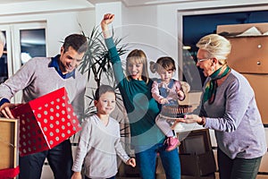 Grandparents bring a gift for moving into a new apartment to their children