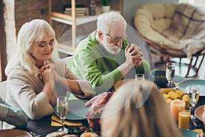Grandparents charming couple gathering sit table celebrate thanksgiving day pray with family relatives have banquet in