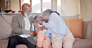 Grandparents, child and tickle or playing on sofa, bonding and affection or laughing for game. Black family, happiness