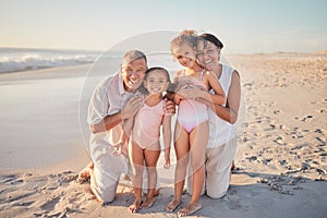Grandparents with children, happy on beach on holiday and enjoying retirement. Grandpa, grandma and kids enjoy afternoon
