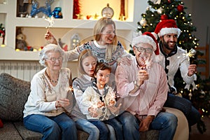Grandparents with children sparkling with Christmas sparkles
