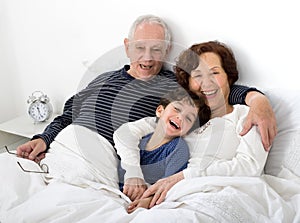 Grandparents grandchild bed photo