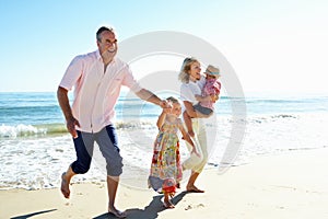 Grandparents And Grandchildren On Beach