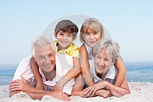 Grandparents And Grandchildren On Beach Holiday