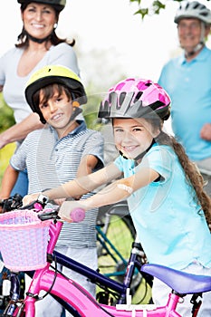 Grandparents And Grandchildren On Cycle Ride In Countryside