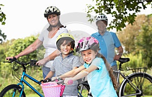 Grandparents And Grandchildren On Cycle Ride In Countryside