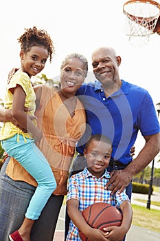 Grandparents And Grandchildren Playing Basketball Together