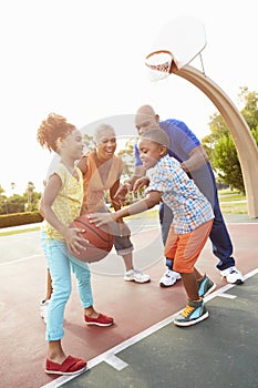 Grandparents And Grandchildren Playing Basketball Together