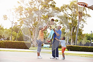 Grandparents And Grandchildren Playing Basketball Together