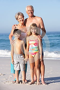 Grandparents And Grandchildren Standing On Beac