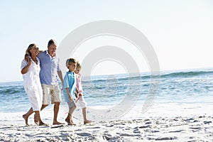Grandparents and Grandchildren Walking Along Beach