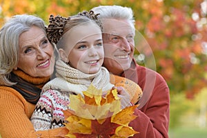 Grandparents and granddaughter in park