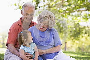 Grandparents with granddaughter in park