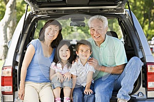 Grandparents with grandkids in tailgate of car