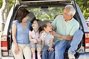 Grandparents with grandkids in tailgate of car