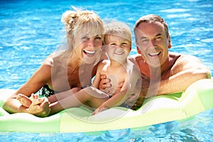 Grandparents And Grandson In Swimming Pool