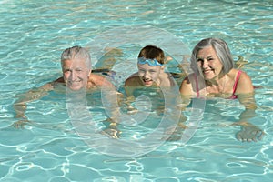 Grandparents with grandson in swimming pool