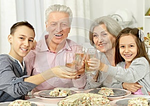 Grandparents and grandsons clanging glasses