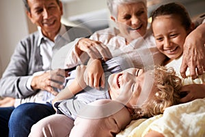 Grandparents, home and grandchildren with happiness, funny and bonding together with vacation and playing. Family, old