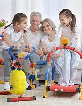Grandparents and little granddaughters doing exercises