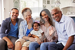 Grandparents and parents with a baby girl on mumï¿½s knee