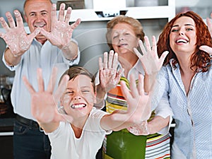 Grandparents, parents and children baking in the kitchen