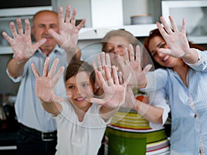 Grandparents, parents and children baking in the kitchen