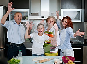 Grandparents, parents and children baking in the kitchen