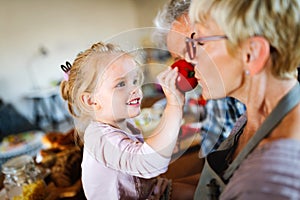 Grandparents playing and having fun with their granddaughter