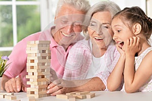 Grandparents playing with her little granddaughter photo