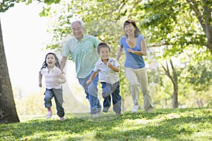 Grandparents running with grandchildren photo