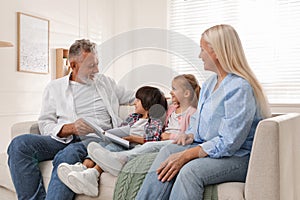 Grandparents spending time with grandchildren at home
