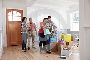 Grandparents Visiting Hispanic Family In New Home photo