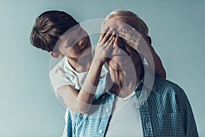 Grandson Covering Grandpa`s Eye Making Surprise