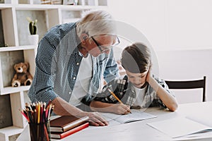 Grandson Doing School Homework with Old Man Home