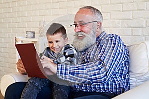 Grandson enjoys reading a book with his granfather