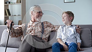 Grandson and grandpa laughing, joking, having good time together, communication