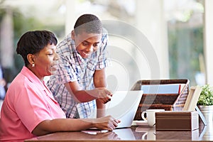 Grandson Helping Grandmother With Laptop