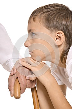 Grandson leaning on grandfathers hand photo